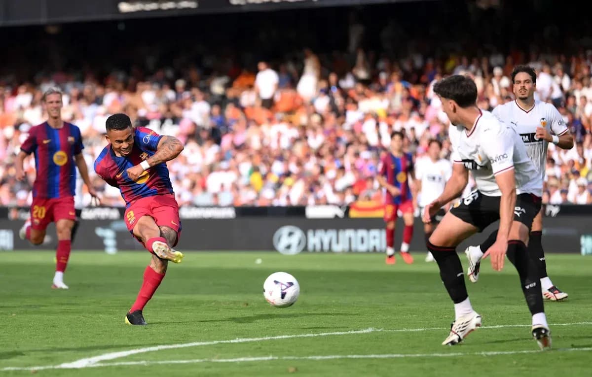 Barcelona player striking the ball in match action Barcelona player striking the ball in match action