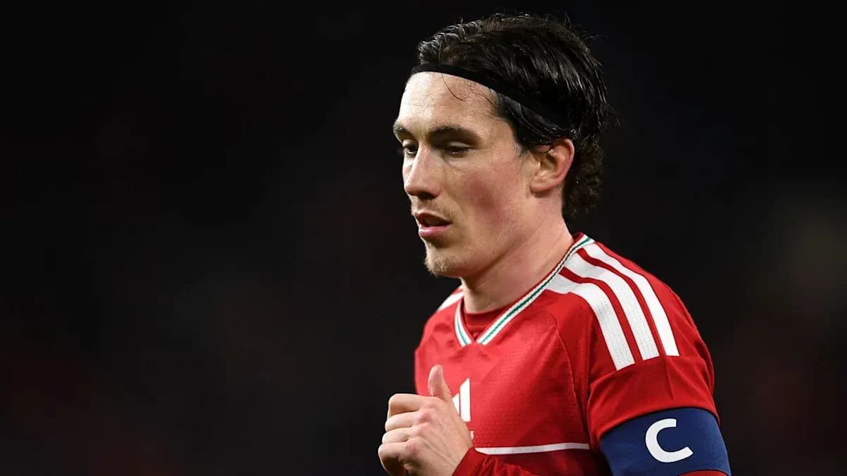 Player in red jersey with captain's armband Player in red jersey with captain's armband