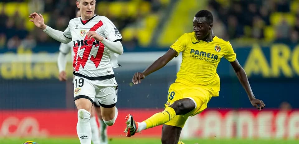 Rayo Vallecano player competing against Villarreal player Rayo Vallecano player competing against Villarreal player