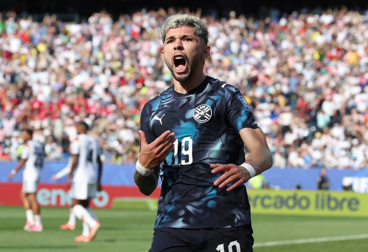 Player celebrating a goal in front of crowd Player celebrating a goal in front of crowd