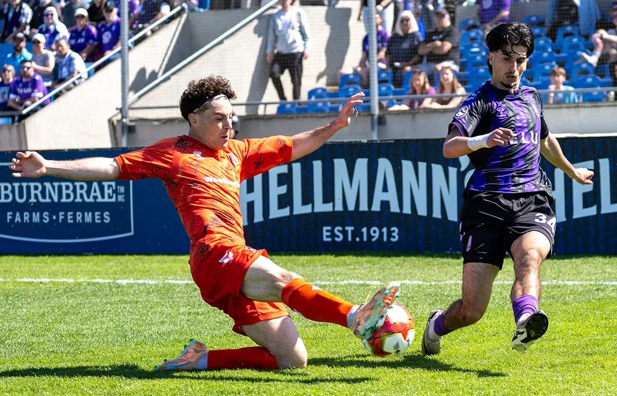 Player sliding tackle during Forge vs Pacific FC match Player sliding tackle during Forge vs Pacific FC match