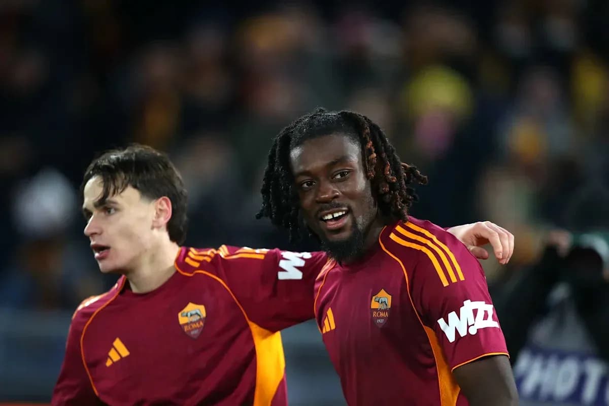 Two AS Roma players celebrating on the pitch Two AS Roma players celebrating on the pitch