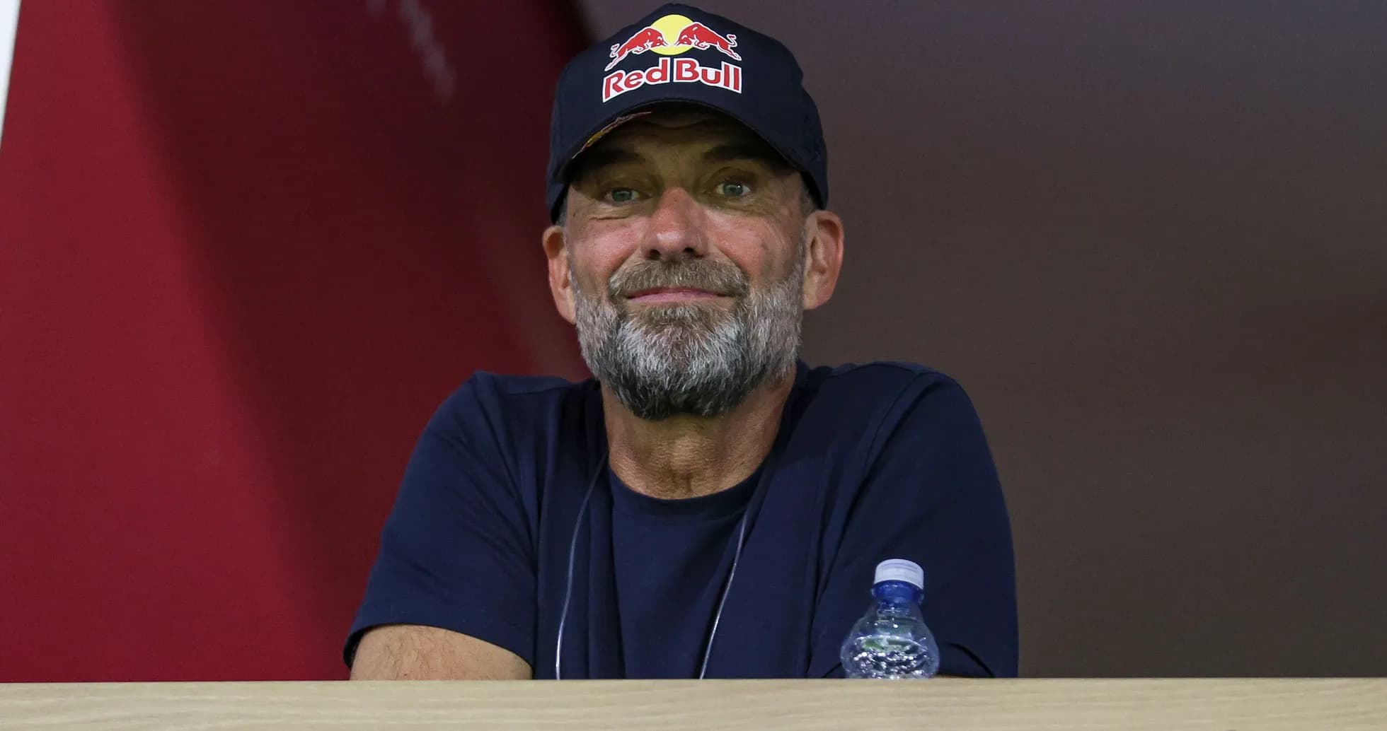 Man wearing Red Bull cap watching from a balcony Man wearing Red Bull cap watching from a balcony