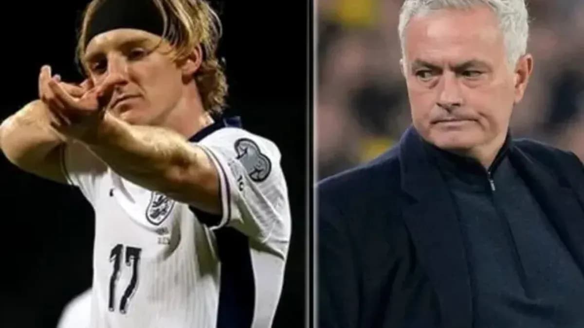 Football player gesturing and coach observing match Football player gesturing and coach observing match