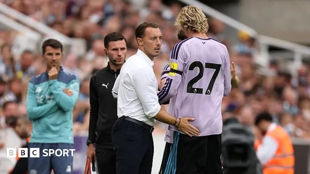 Coach discussing with goalkeeper during match substitution Coach discussing with goalkeeper during match substitution