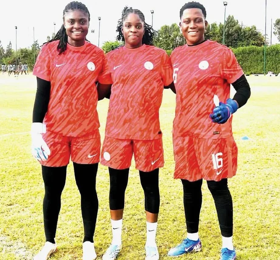 Three female football players posing in training kits Three female football players posing in training kits
