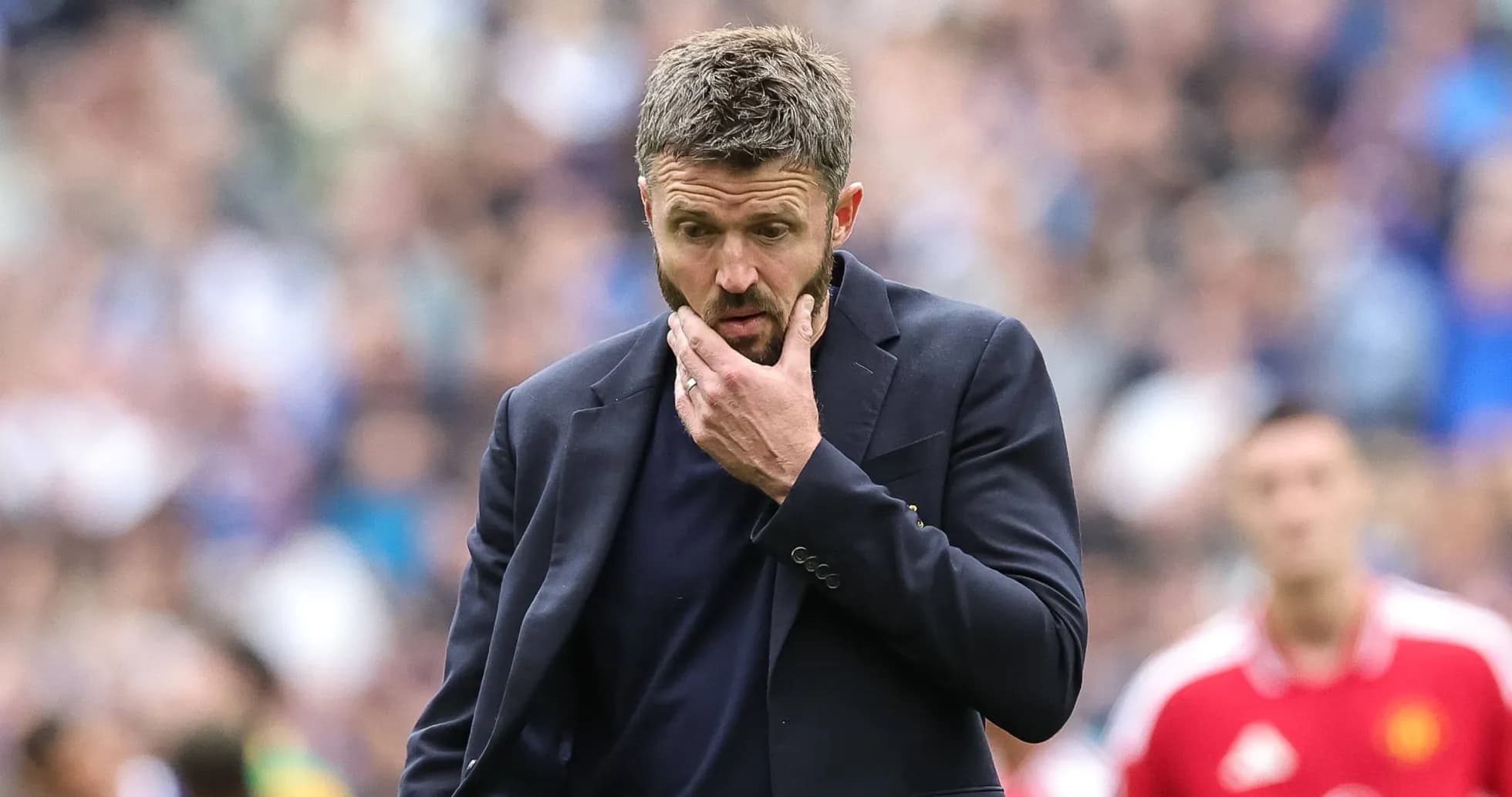 Coach in a suit pondering during a match Coach in a suit pondering during a match