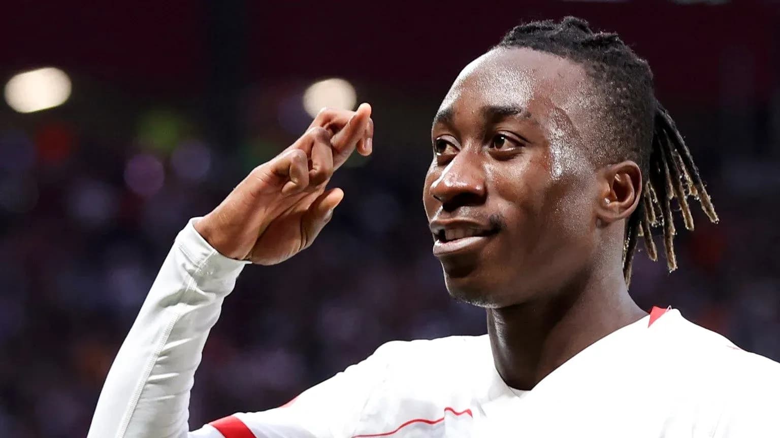 Player celebrating with a salute gesture after scoring Player celebrating with a salute gesture after scoring