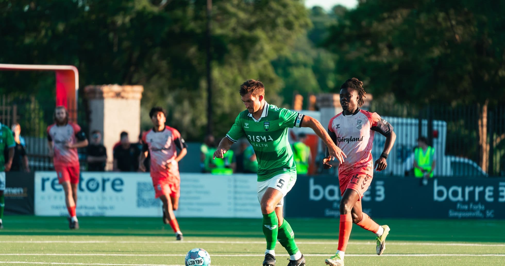 Player dribbling the ball during football match Player dribbling the ball during football match