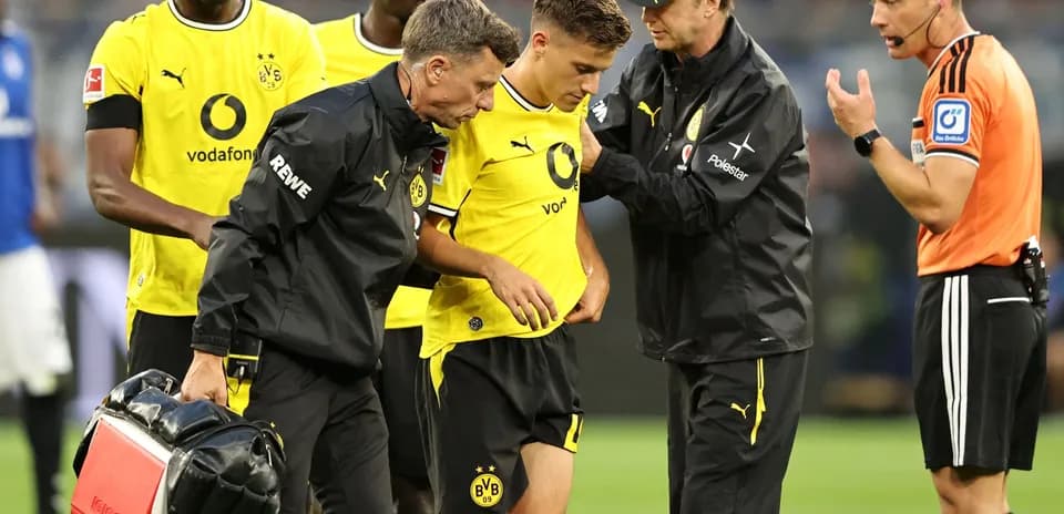 Borussia Dortmund player receiving medical attention on pitch Borussia Dortmund player receiving medical attention on pitch