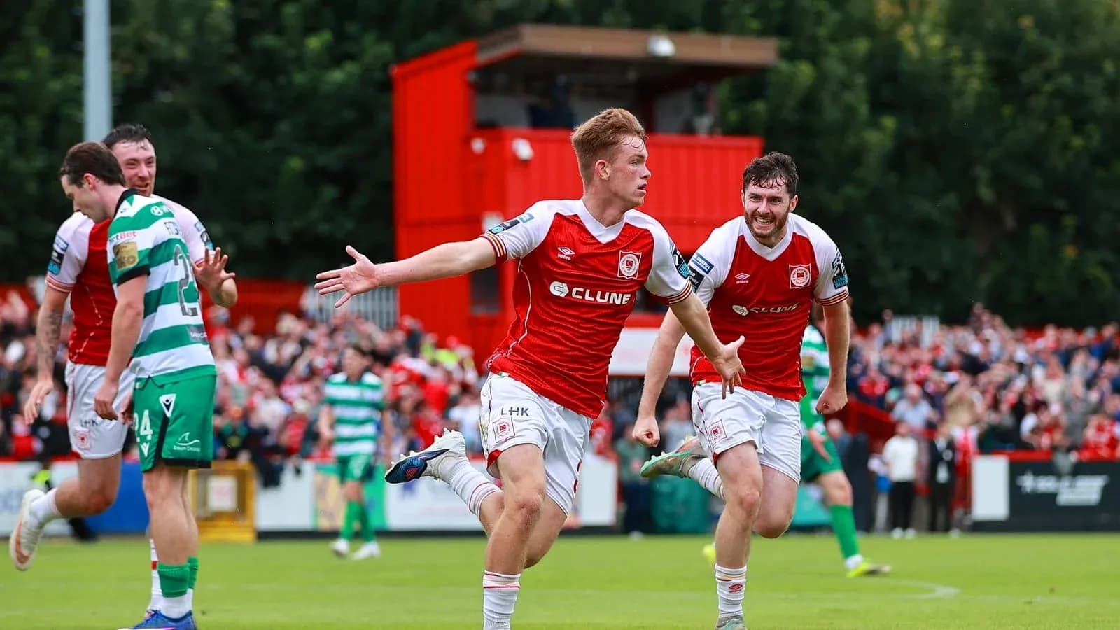 Player celebrating goal with teammates in stadium Player celebrating goal with teammates in stadium