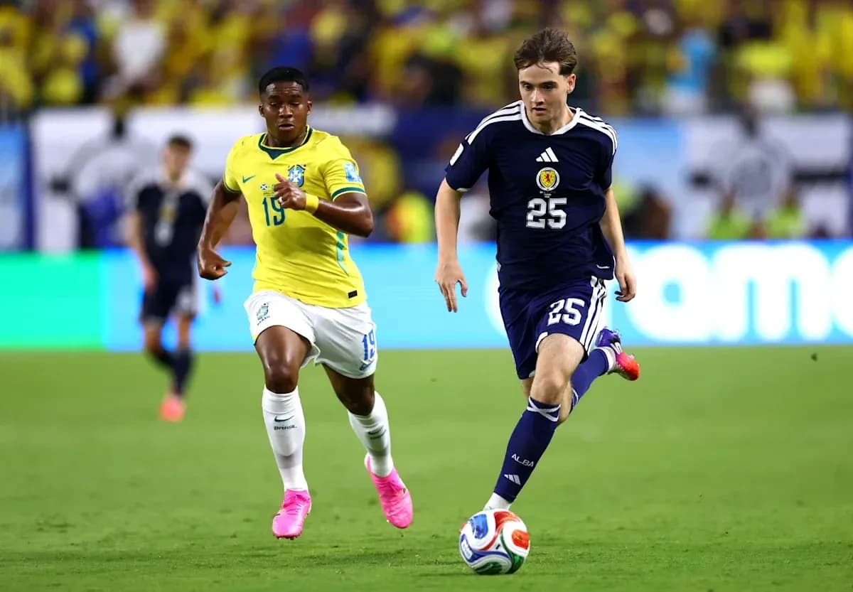 Player from Scotland sprinting with ball, Brazilian defender chasing Player from Scotland sprinting with ball, Brazilian defender chasing