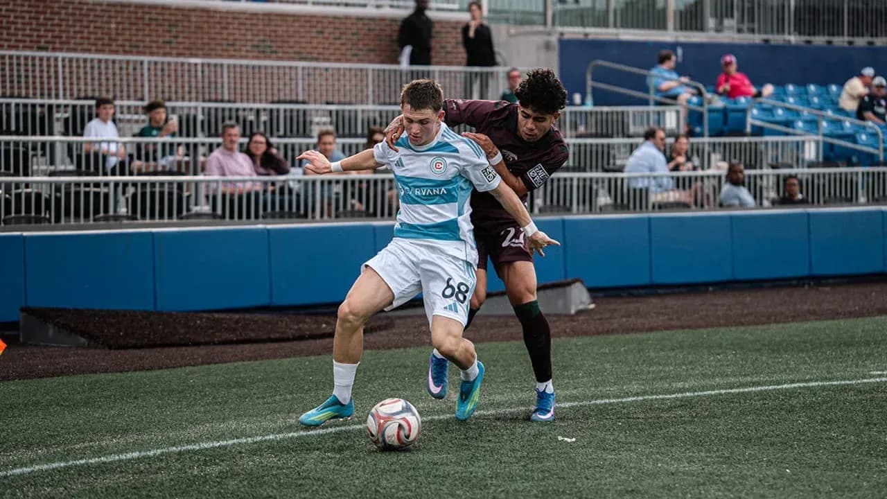 Player competing for the ball in MLS Next Pro match Player competing for the ball in MLS Next Pro match