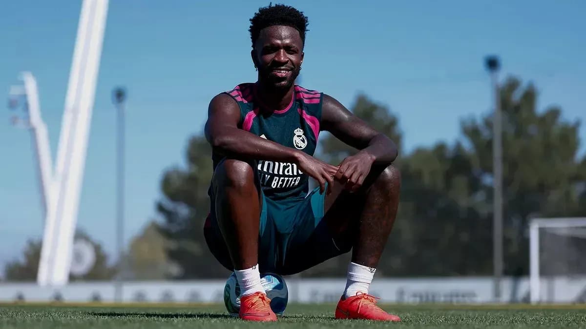 Player sitting on soccer ball during training session Player sitting on soccer ball during training session