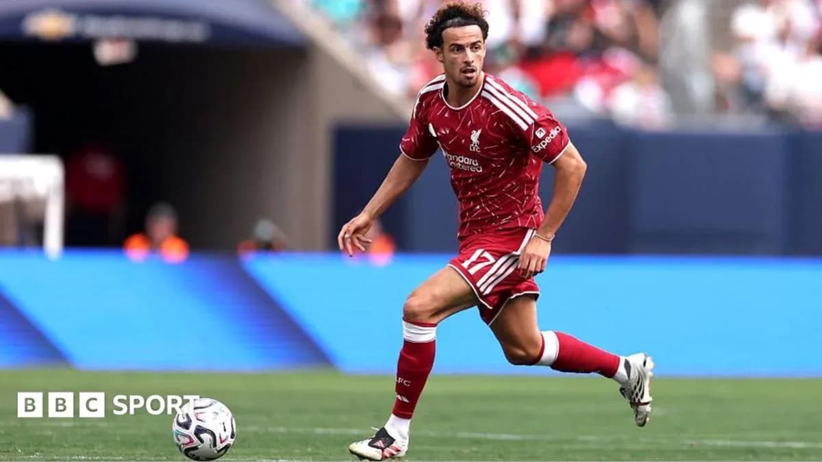 Player in red Liverpool kit dribbling the ball Player in red Liverpool kit dribbling the ball