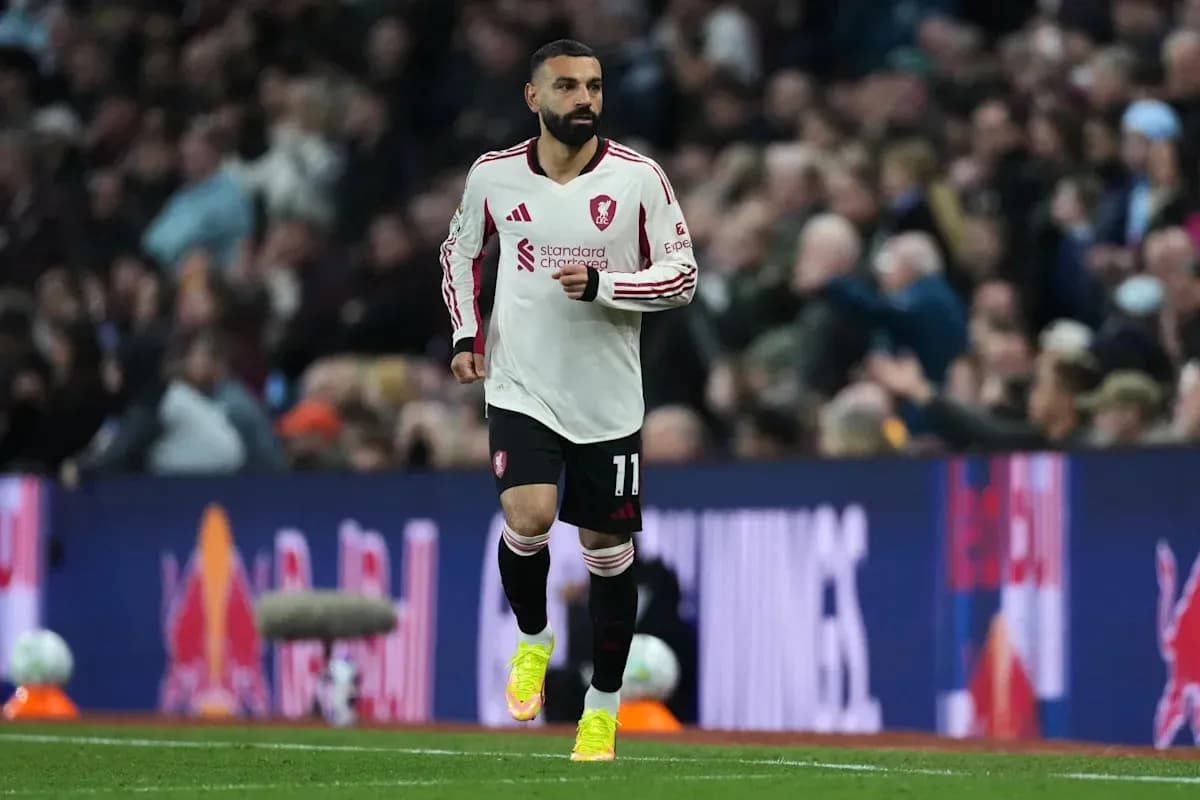 Player wearing Liverpool kit running on pitch Player wearing Liverpool kit running on pitch