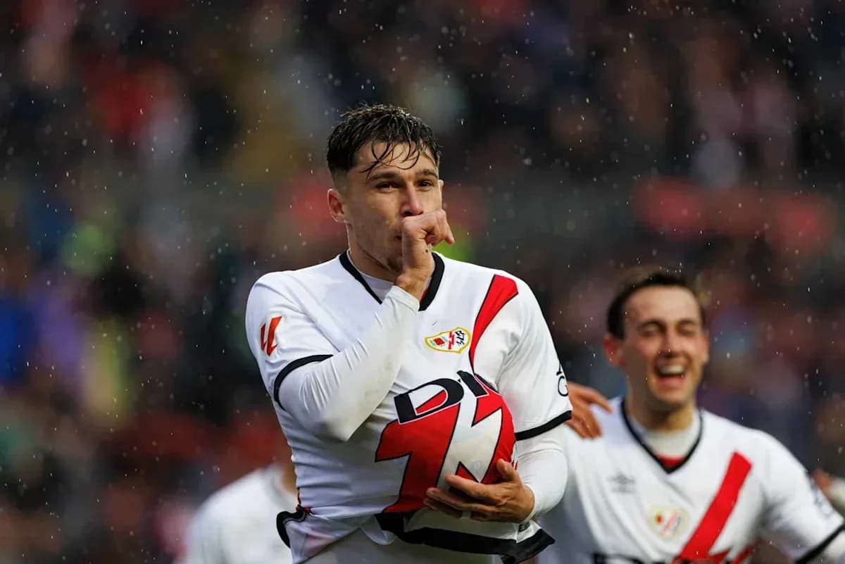 Player celebrating goal with teammates in rain Player celebrating goal with teammates in rain