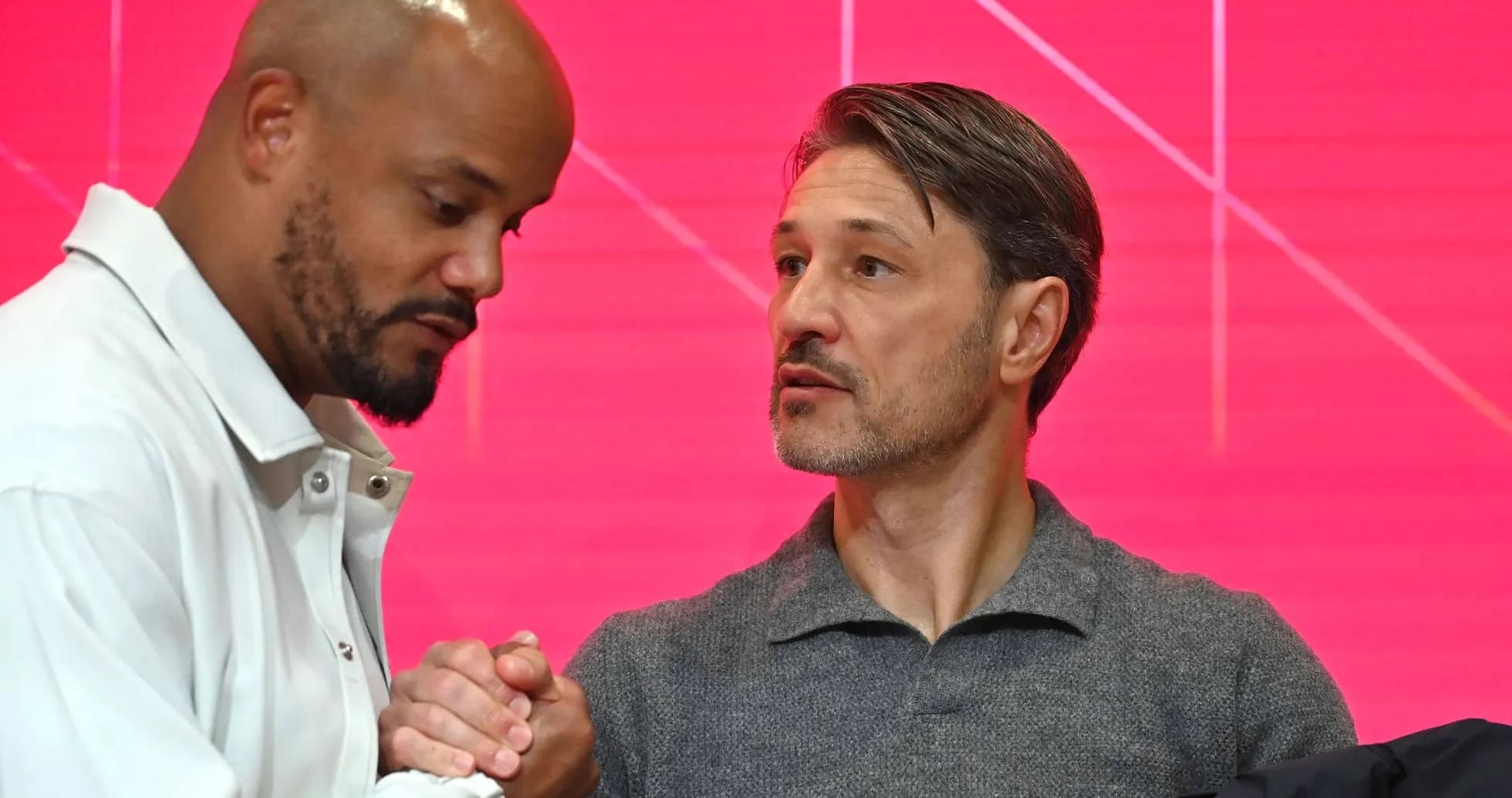 Two men shaking hands at an event Two men shaking hands at an event