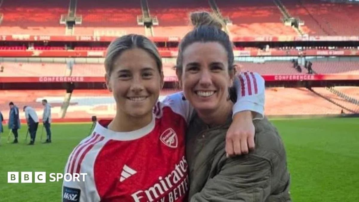 Two women posing together on football pitch Two women posing together on football pitch