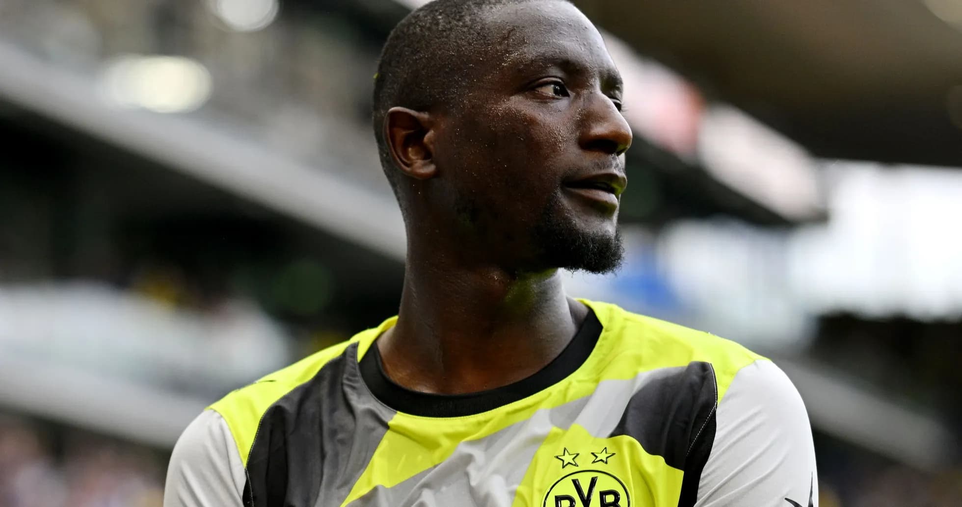 Player wearing Borussia Dortmund jersey on the field Player wearing Borussia Dortmund jersey on the field