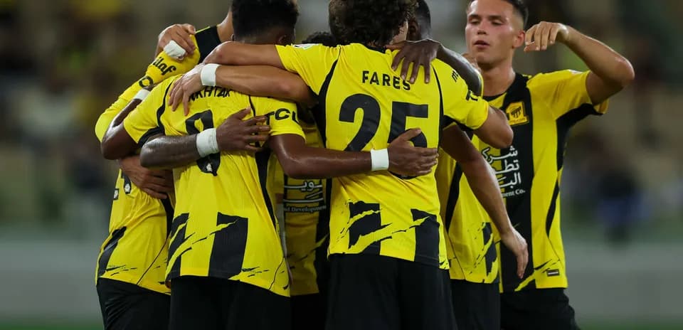 Players celebrating together in yellow jerseys Players celebrating together in yellow jerseys