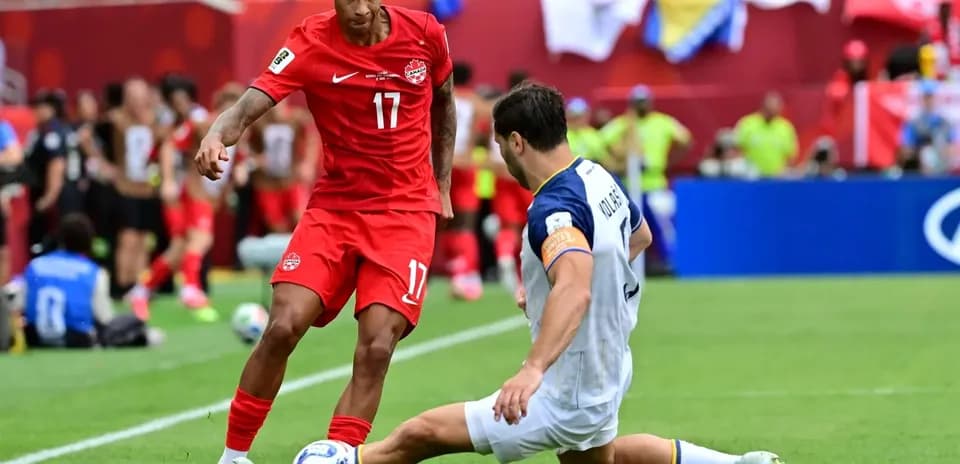 Canada player evading tackle during World Cup match Canada player evading tackle during World Cup match