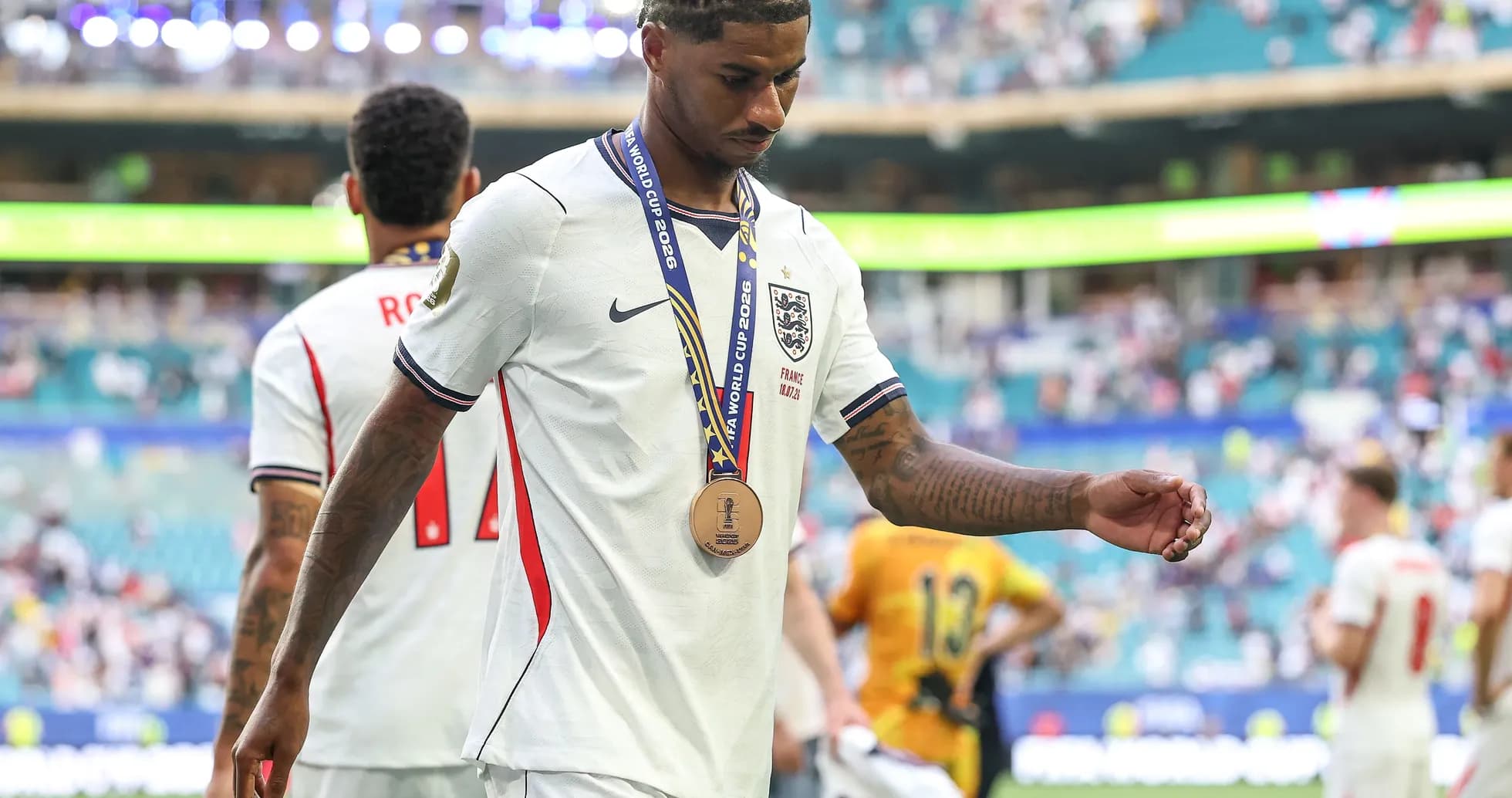 Player walking off field wearing bronze medal Player walking off field wearing bronze medal