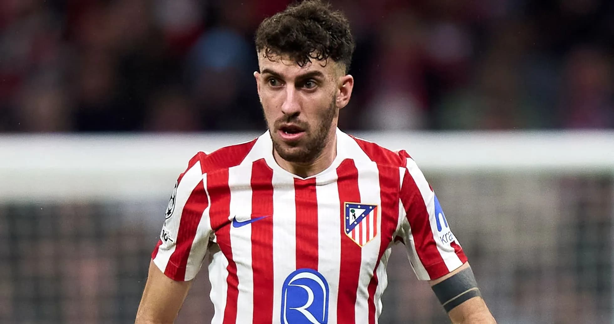Player in red and white striped jersey during match Player in red and white striped jersey during match