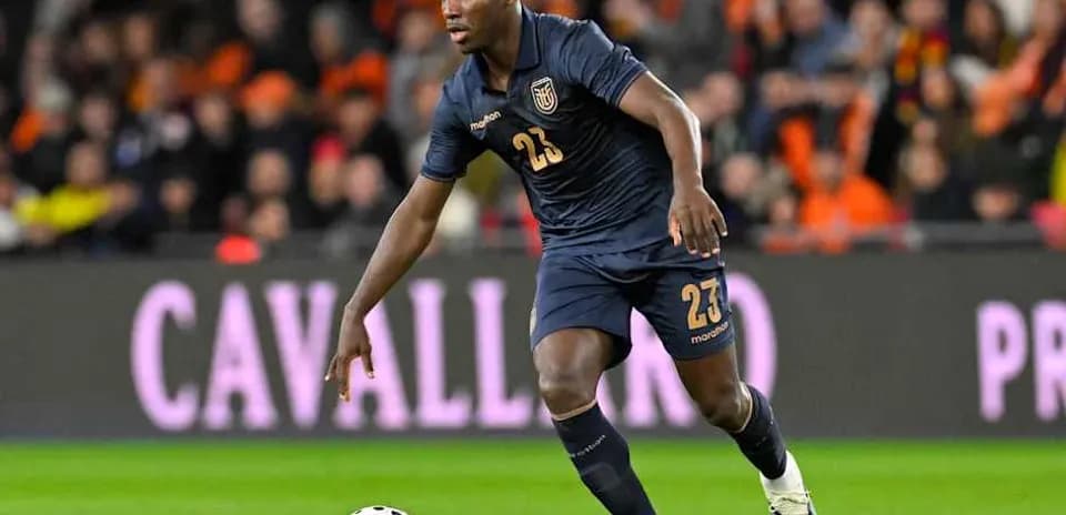 Player in dark jersey dribbling ball on field Player in dark jersey dribbling ball on field