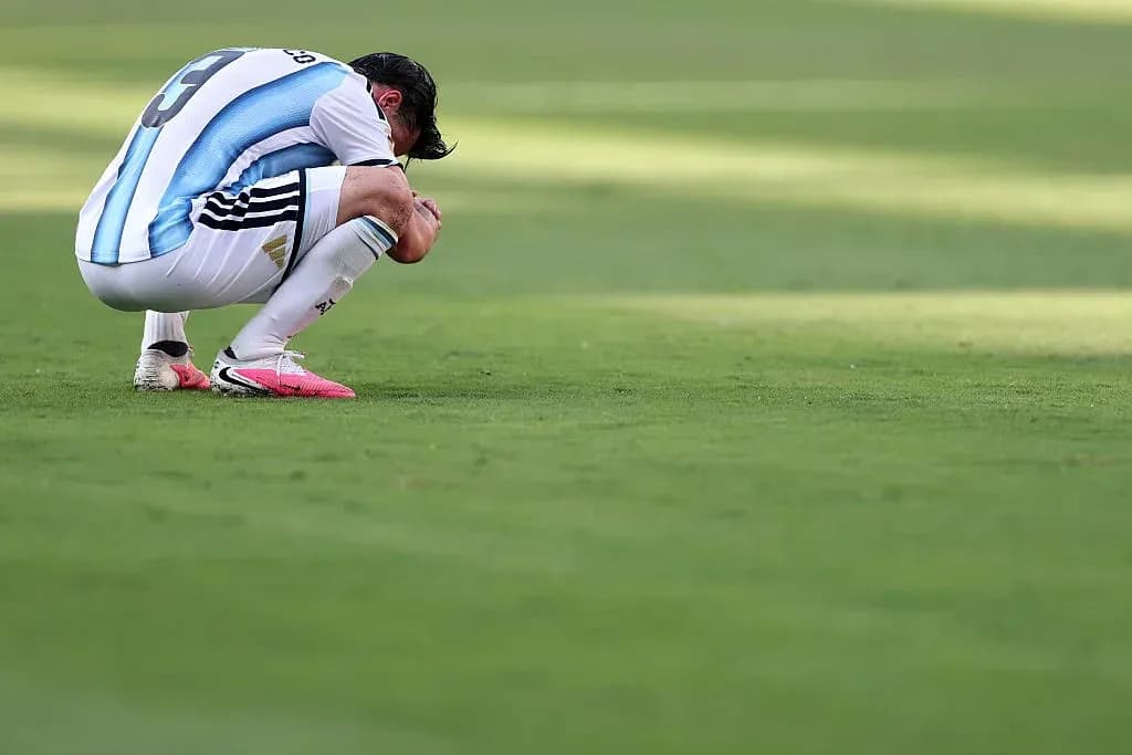 Player kneeling on the pitch during a match Player kneeling on the pitch during a match