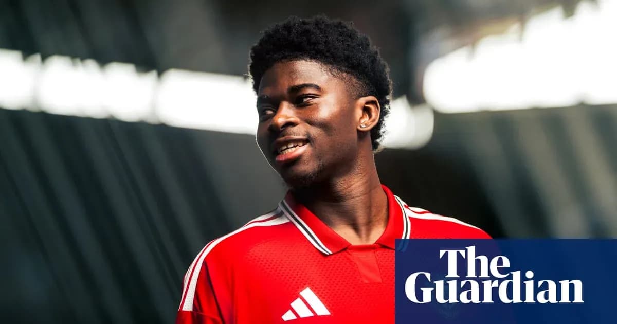 Player in red jersey smiling during photoshoot Player in red jersey smiling during photoshoot