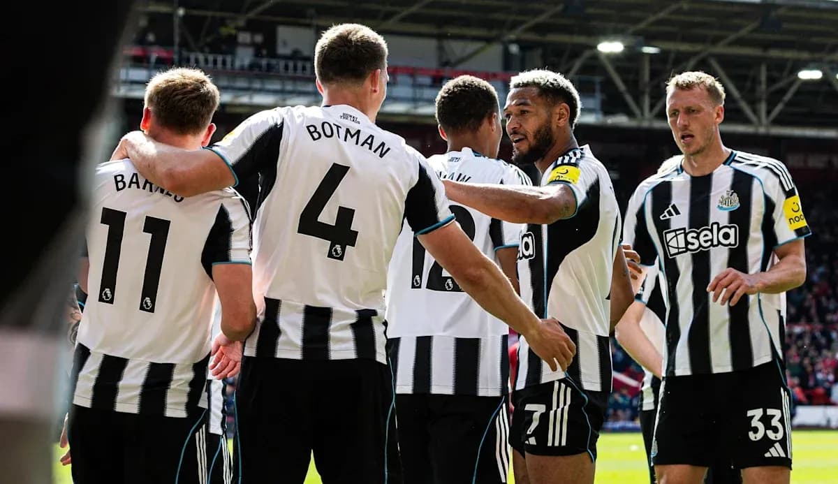 Newcastle players celebrating a goal on the pitch Newcastle players celebrating a goal on the pitch