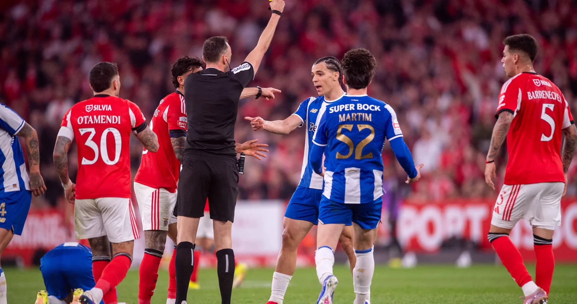 Referee showing yellow card during football match Referee showing yellow card during football match