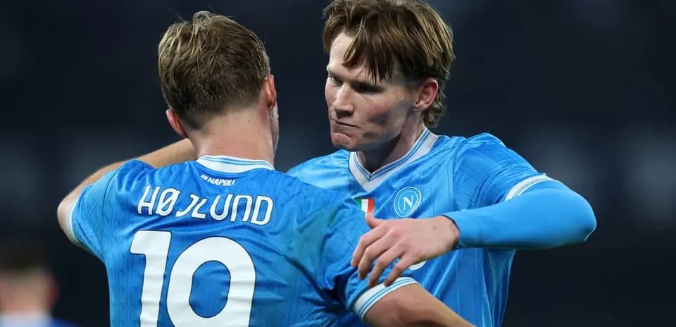 Two Napoli players embracing on the pitch Two Napoli players embracing on the pitch