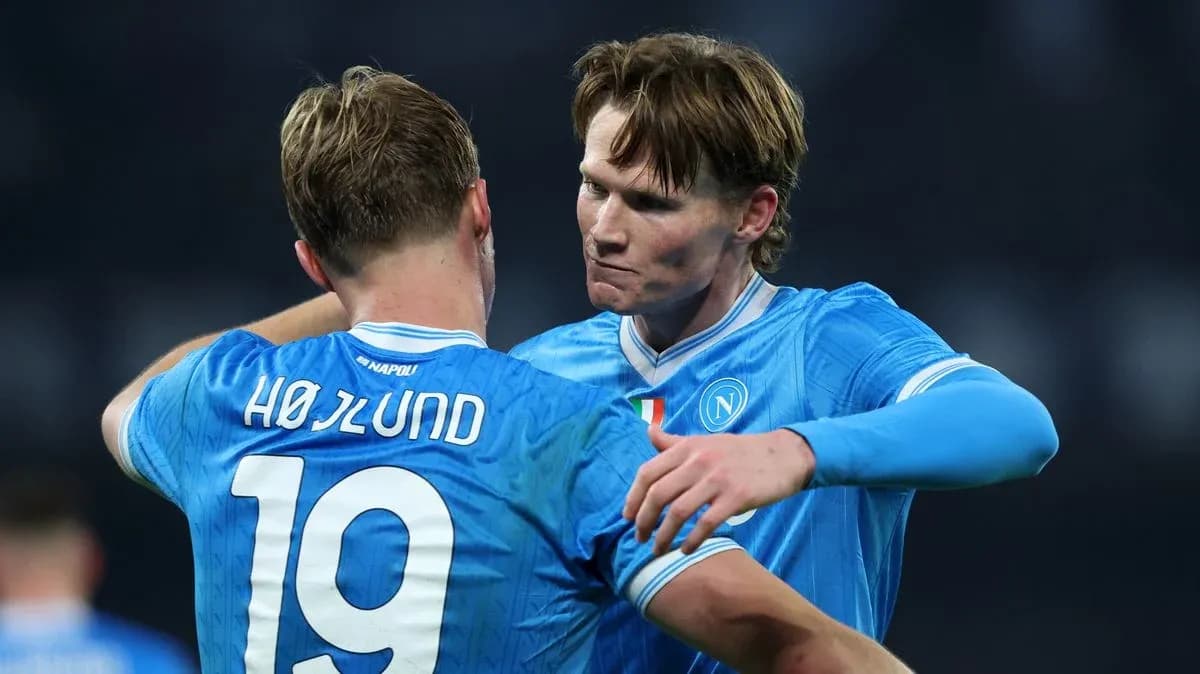 Two Napoli players embracing on the pitch Two Napoli players embracing on the pitch