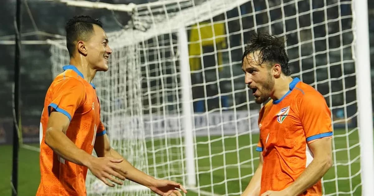 Two players celebrating a goal near the goalpost Two players celebrating a goal near the goalpost