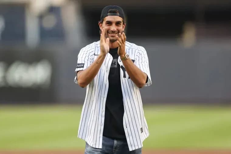Person in Yankees jersey applauding on field Person in Yankees jersey applauding on field
