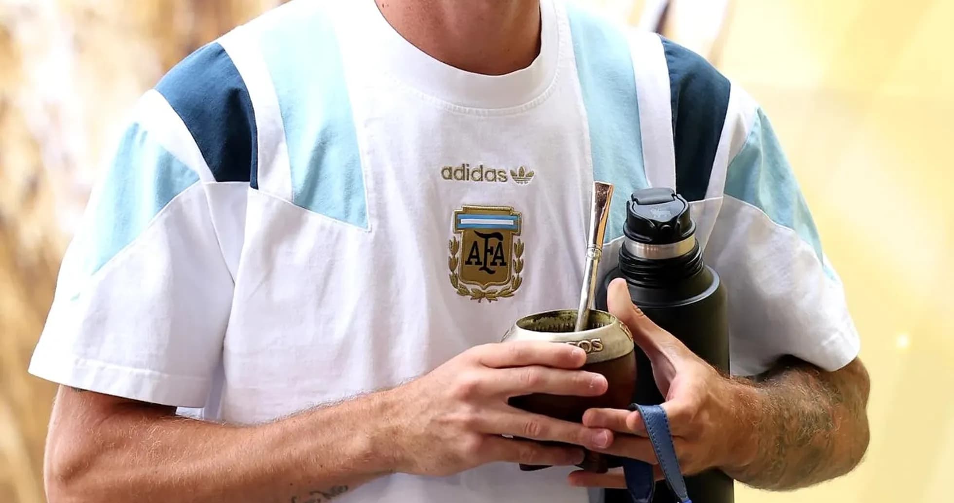 Player holding mate and water bottle in training gear Player holding mate and water bottle in training gear