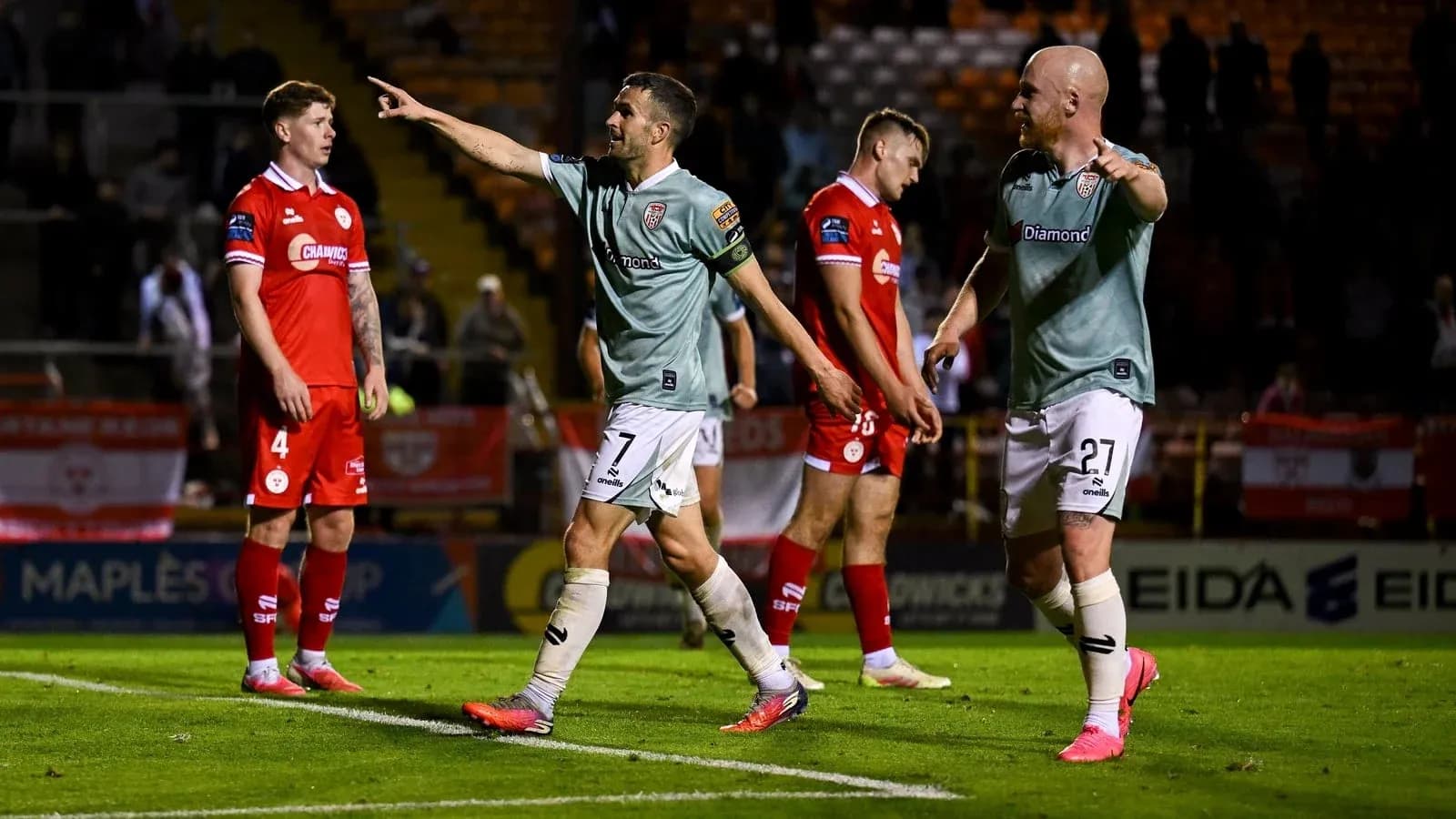 Players celebrating a goal during a football match Players celebrating a goal during a football match