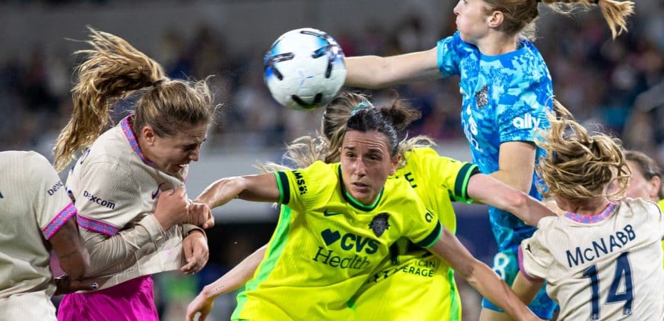 Players competing for the ball during NWSL match Players competing for the ball during NWSL match