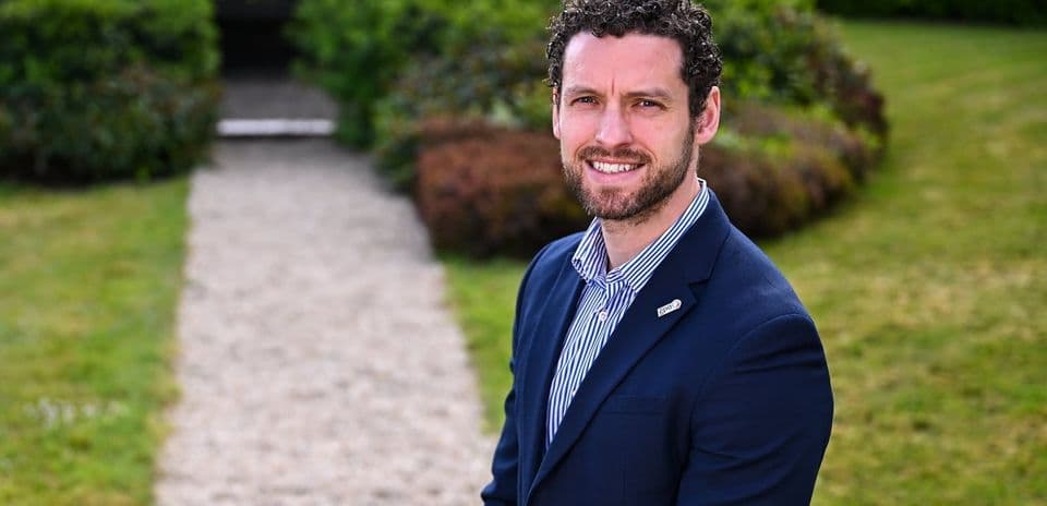 Man in suit standing on a garden path Man in suit standing on a garden path