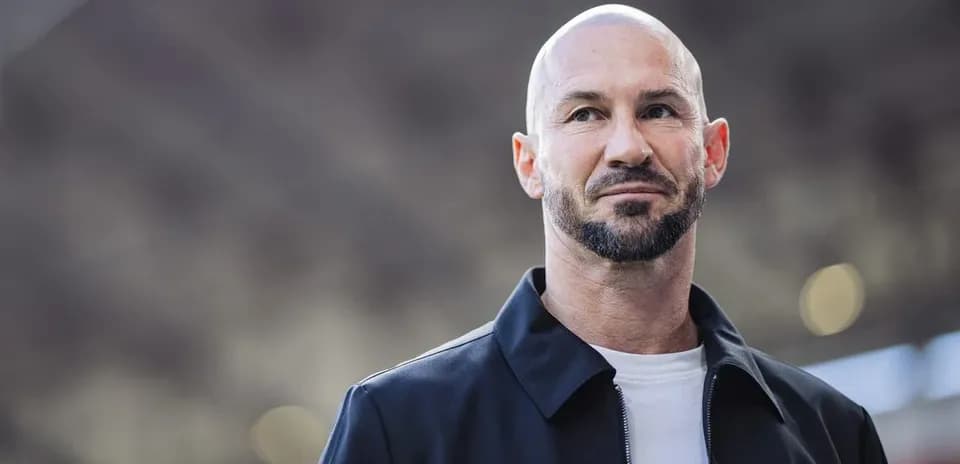 Man with beard and bald head standing outdoors Man with beard and bald head standing outdoors