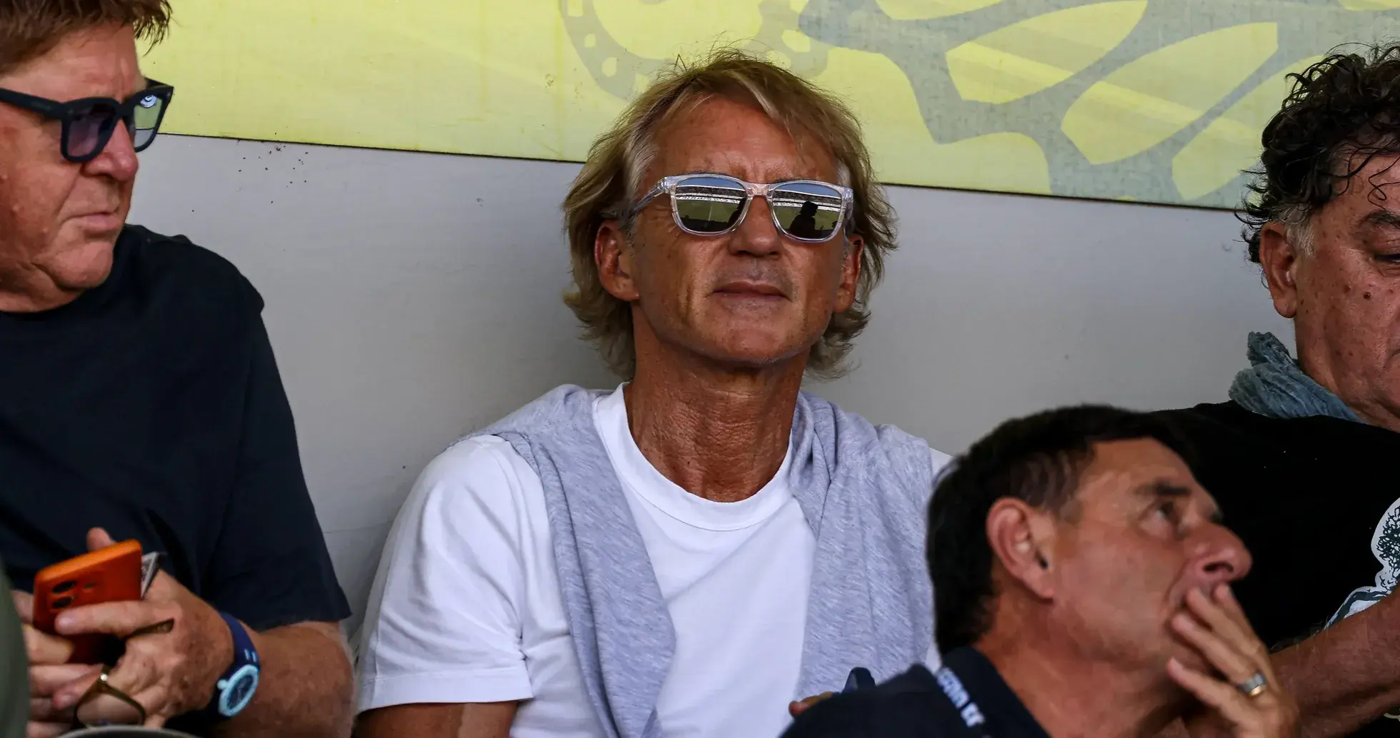 Man with sunglasses sitting among spectators Man with sunglasses sitting among spectators