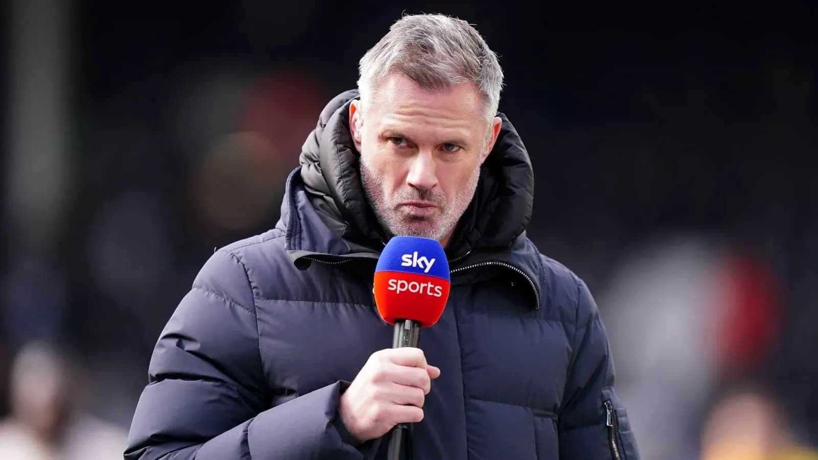 Sports commentator holding microphone during broadcast Sports commentator holding microphone during broadcast