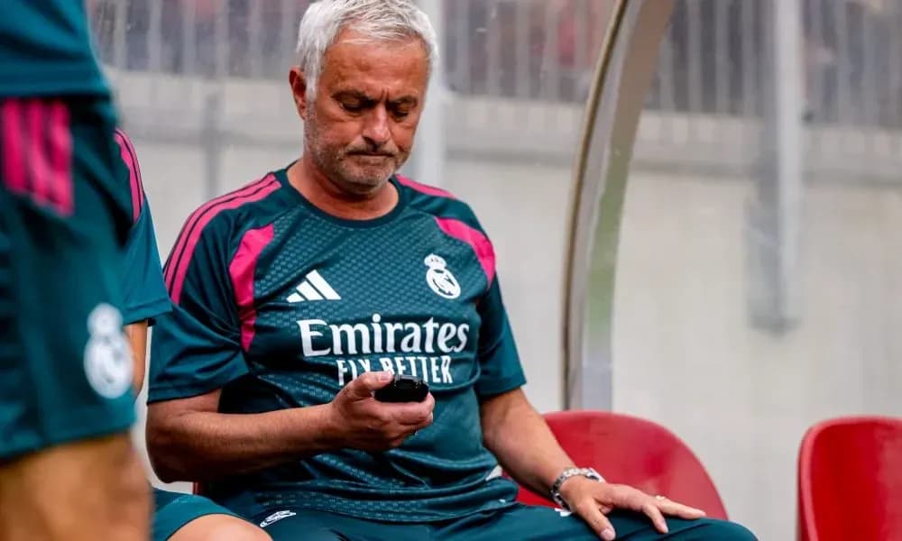 Coach sitting on bench, checking phone during match Coach sitting on bench, checking phone during match