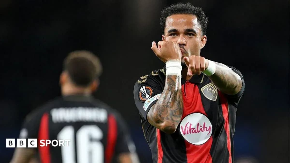 Player celebrating a goal with teammates in match Player celebrating a goal with teammates in match