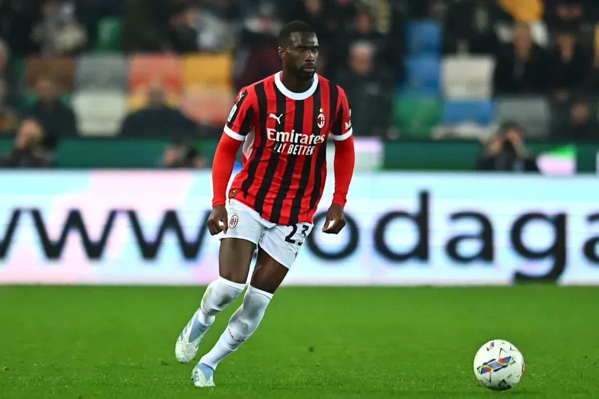 AC Milan player running with the ball on field AC Milan player running with the ball on field