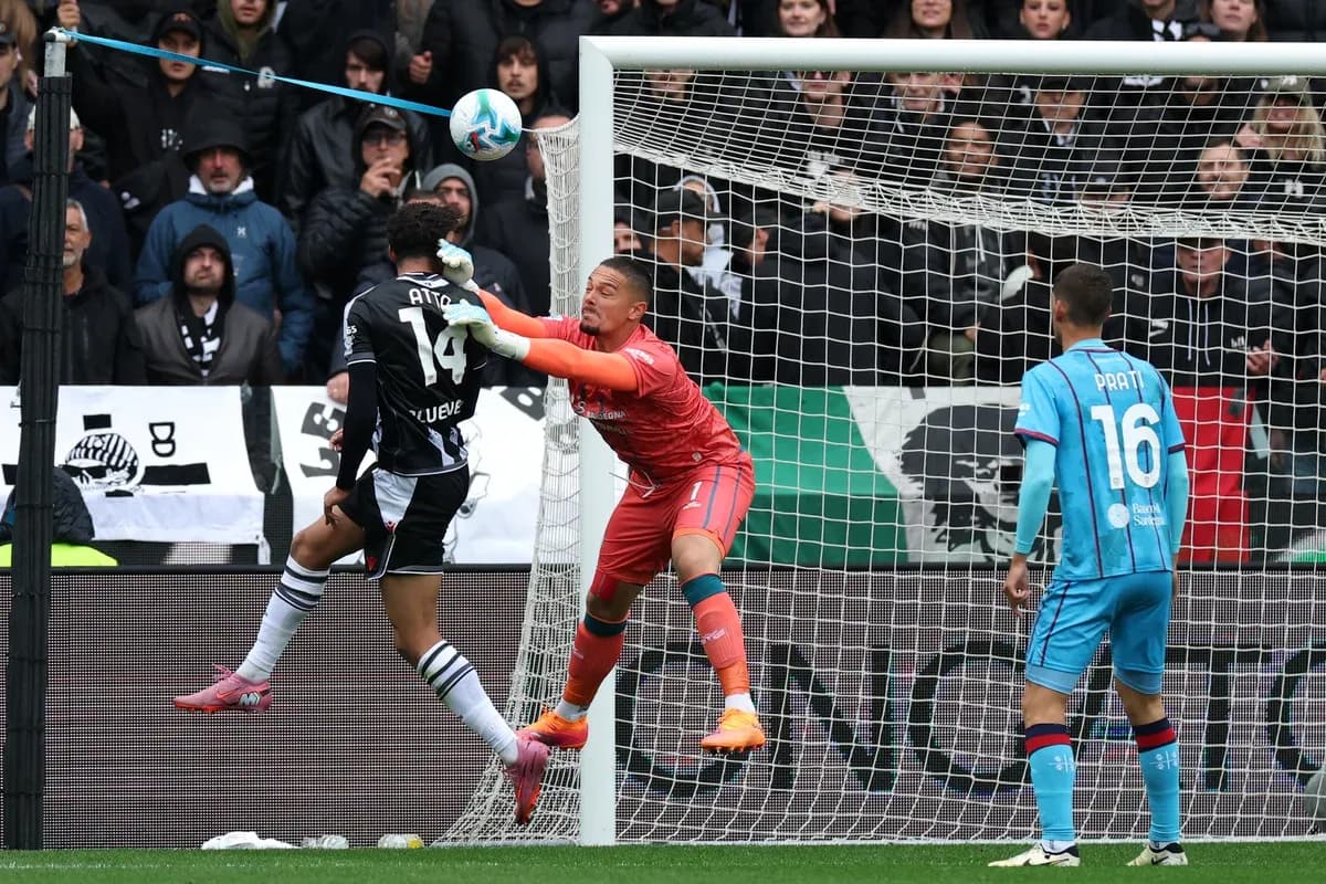 Goalkeeper challenges opponent during Serie A match Goalkeeper challenges opponent during Serie A match