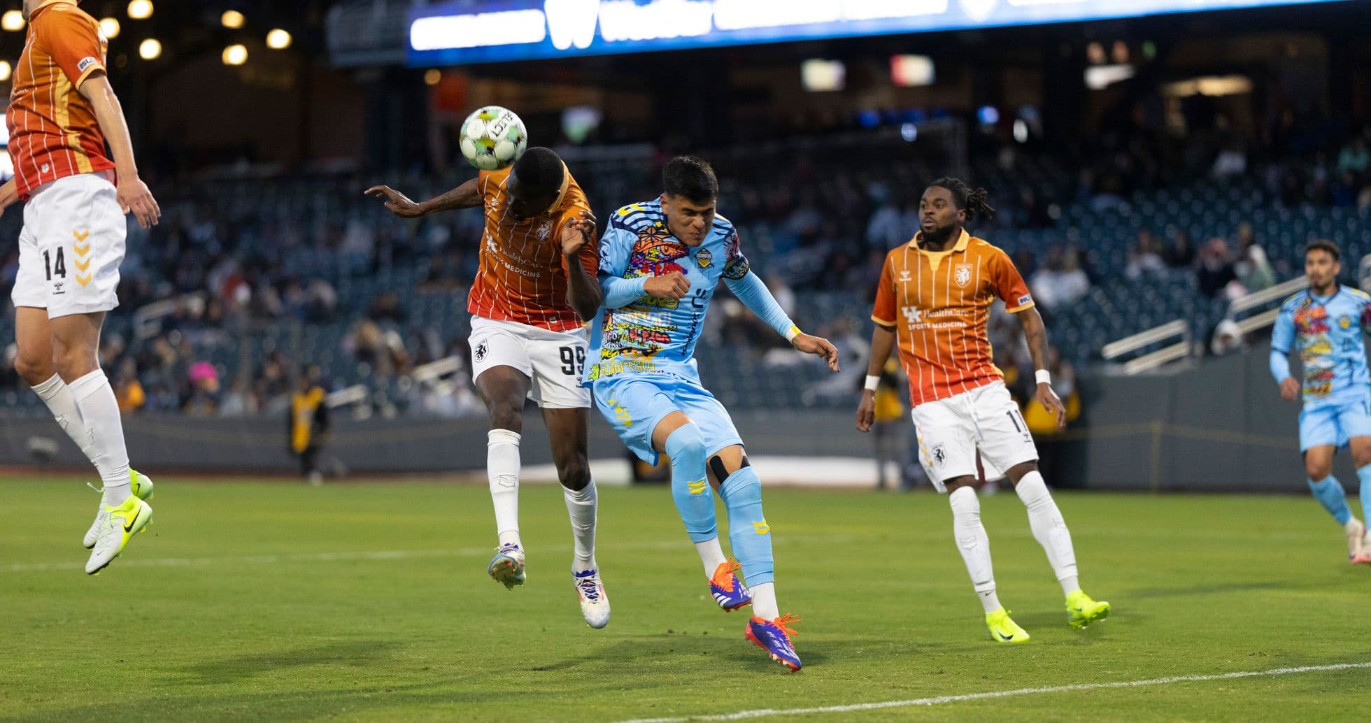 Players competing for the ball during USL match Players competing for the ball during USL match