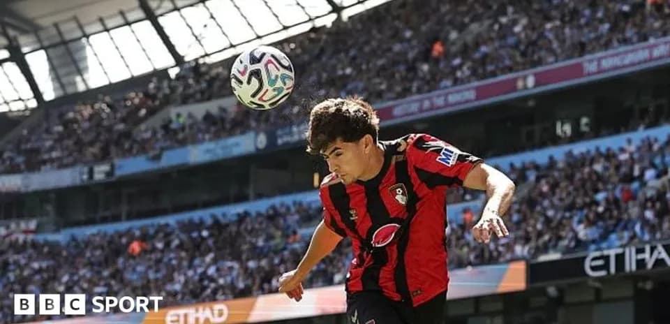 Player heading the ball during match at Etihad Stadium Player heading the ball during match at Etihad Stadium